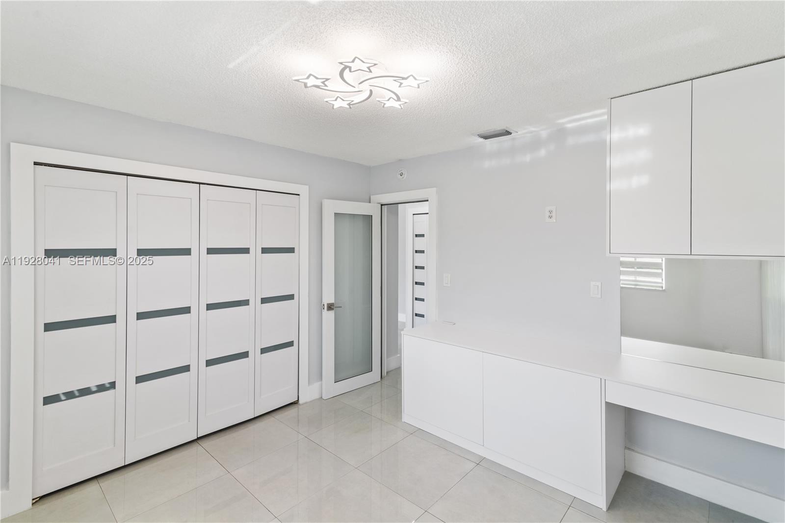 3375 West 76th Street, Unit 210 Hialeah, FL 33018 - Photo 20 of 31 a view of a cabinet with cabinet and chandelier fan