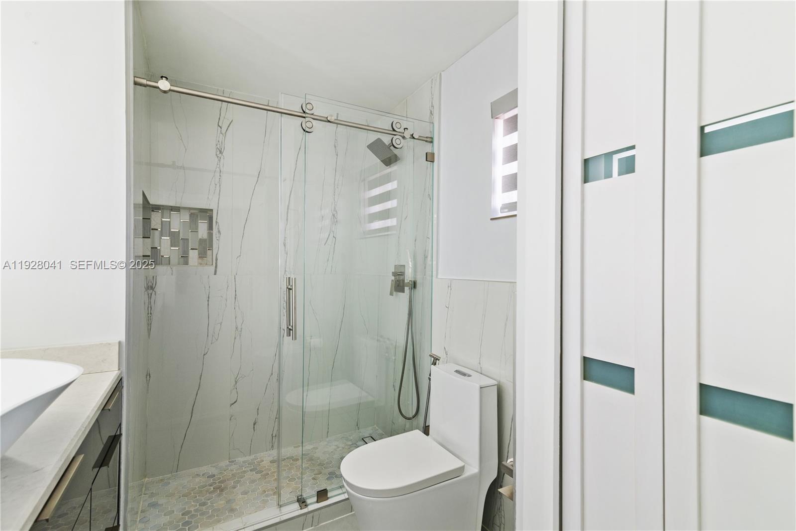 3375 West 76th Street, Unit 210 Hialeah, FL 33018 - Photo 21 of 31 a bathroom with a shower a toilet and a sink