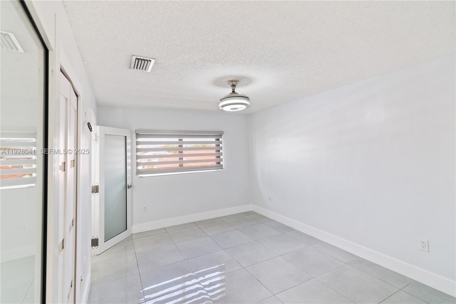 3375 West 76th Street, Unit 210 Hialeah, FL 33018 - Photo 24 of 31 an empty room with windows and entrance