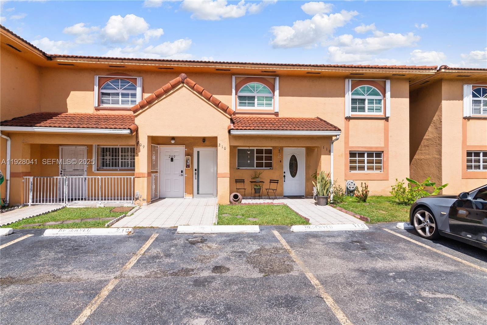 3375 West 76th Street, Unit 210 Hialeah, FL 33018 - Photo 4 of 31 a front view of a house with a yard and porch
