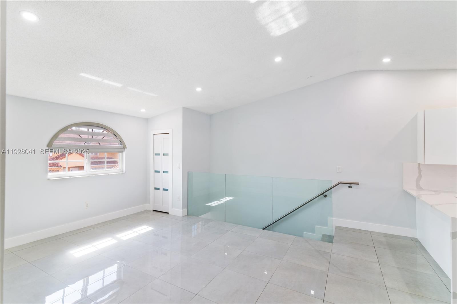 3375 West 76th Street, Unit 210 Hialeah, FL 33018 - Photo 5 of 31 a view of an empty room with a window