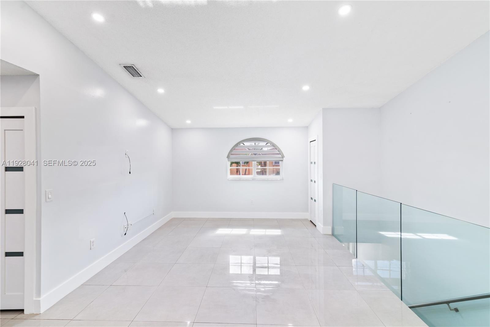 3375 West 76th Street, Unit 210 Hialeah, FL 33018 - Photo 7 of 31 a view of a hallway with a large window