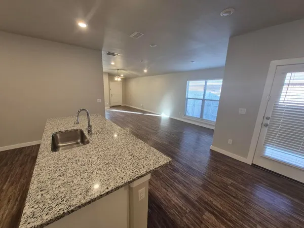 a kitchen with sink and mirror