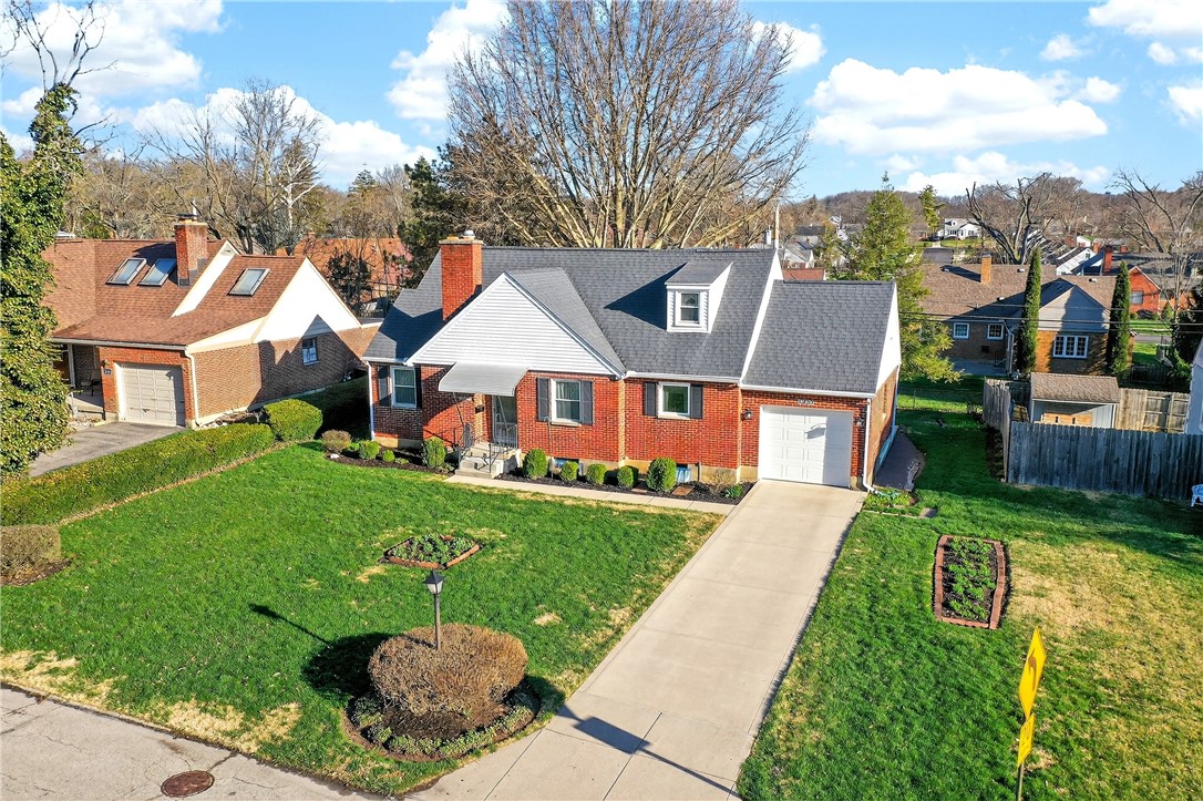 1237 Laurelwood Road Dayton, OH 45409 - Photo 45 of 56 This classic brick residence features a lush lawn and an attached garage.