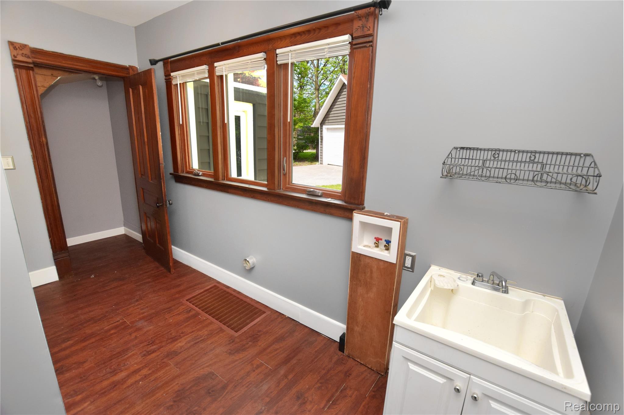 404 North Adelaide Street Fenton, MI 48430 - Photo 11 of 23 Utility space featuring rich wood-finish flooring and light gray walls