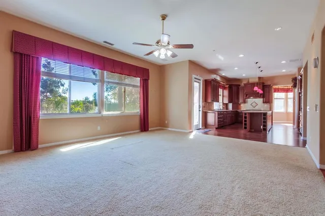 a bathroom with a granite countertop sink a toilet and mirror