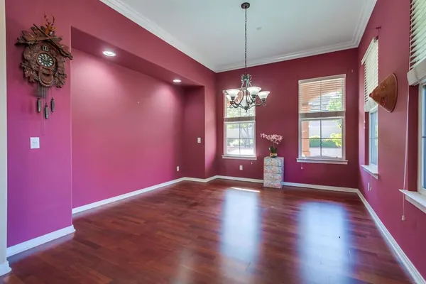 a view of wooden floor and chandelier in a room