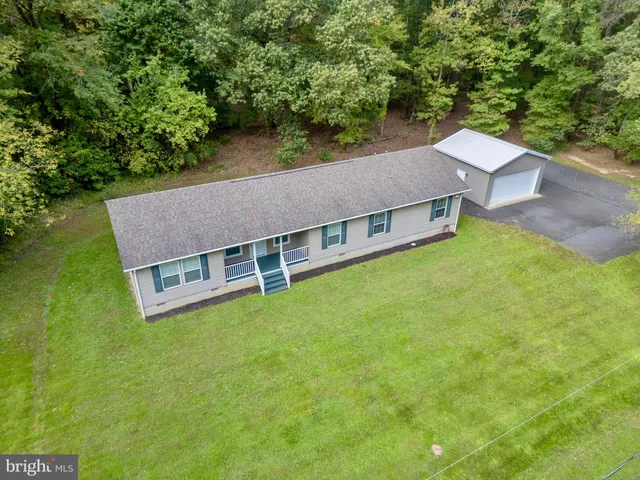 an aerial view of a house with a yard