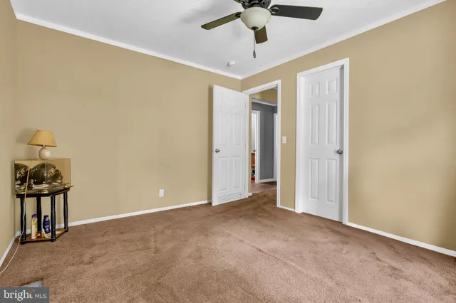a spacious bedroom with a bed and a chandelier