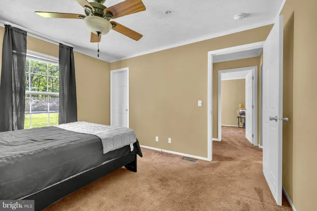 a spacious bedroom with a bed and a chandelier
