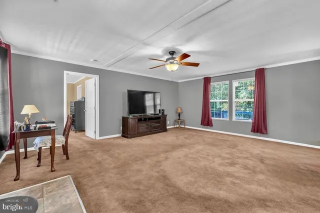 a view of a livingroom with furniture and a flat screen tv