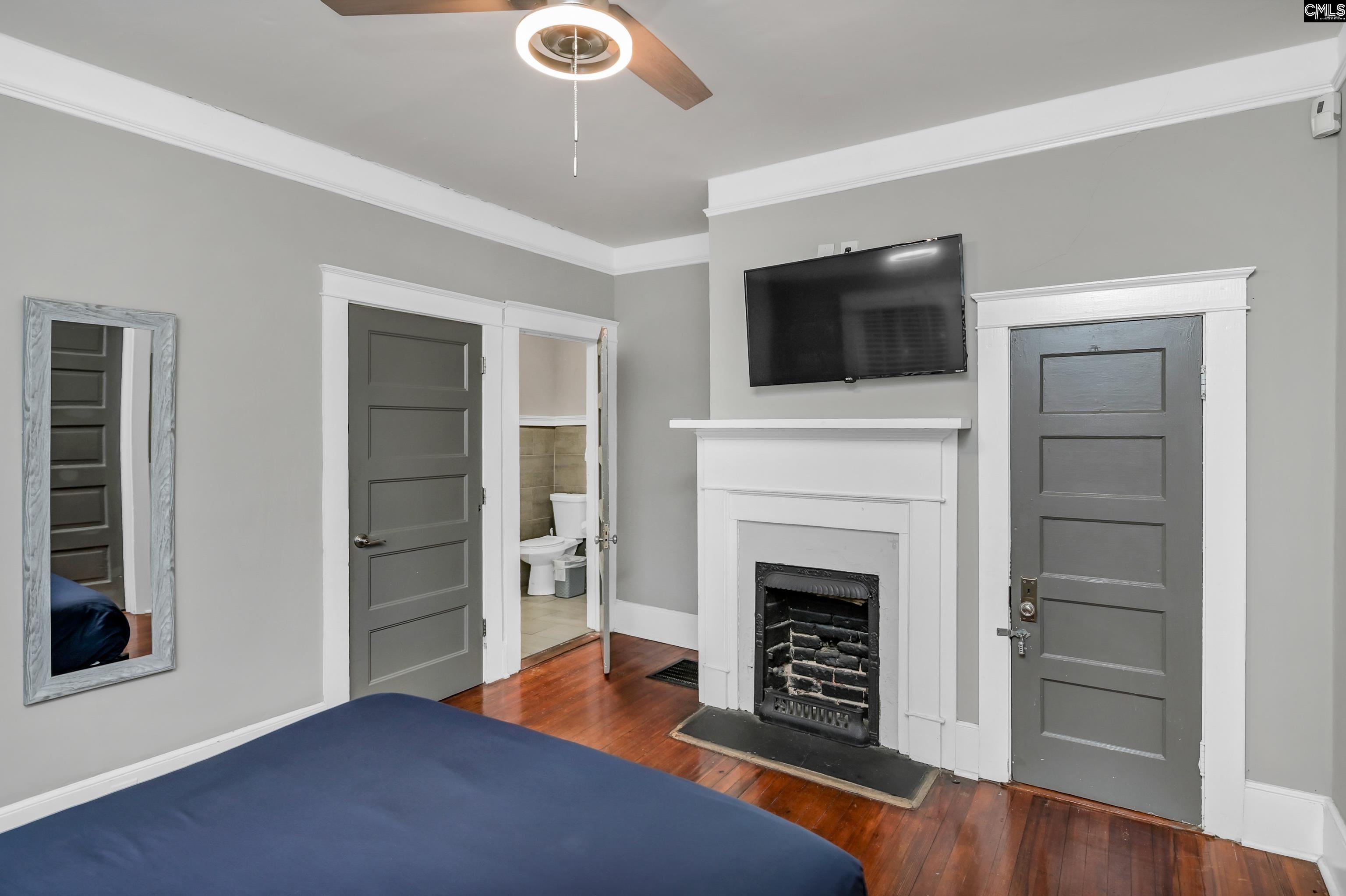 2227 Bull Street Columbia, SC 29201 - Photo 19 of 38 a view of a livingroom with a fireplace a ceiling fan and windows