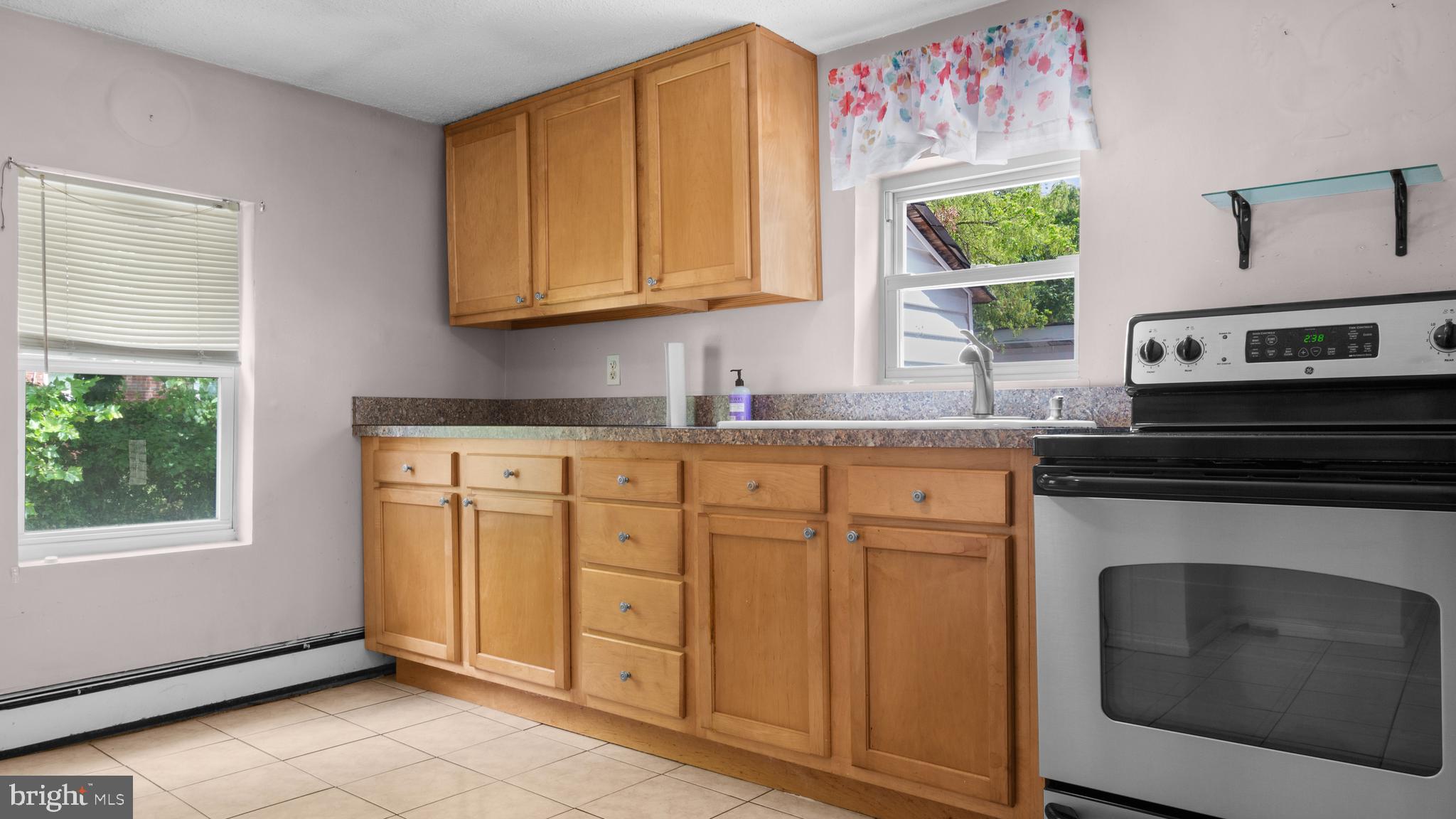 2207 Floral Park Road Clinton, MD 20735 - Photo 11 of 46 a kitchen with stainless steel appliances granite countertop a stove a sink and a microwave