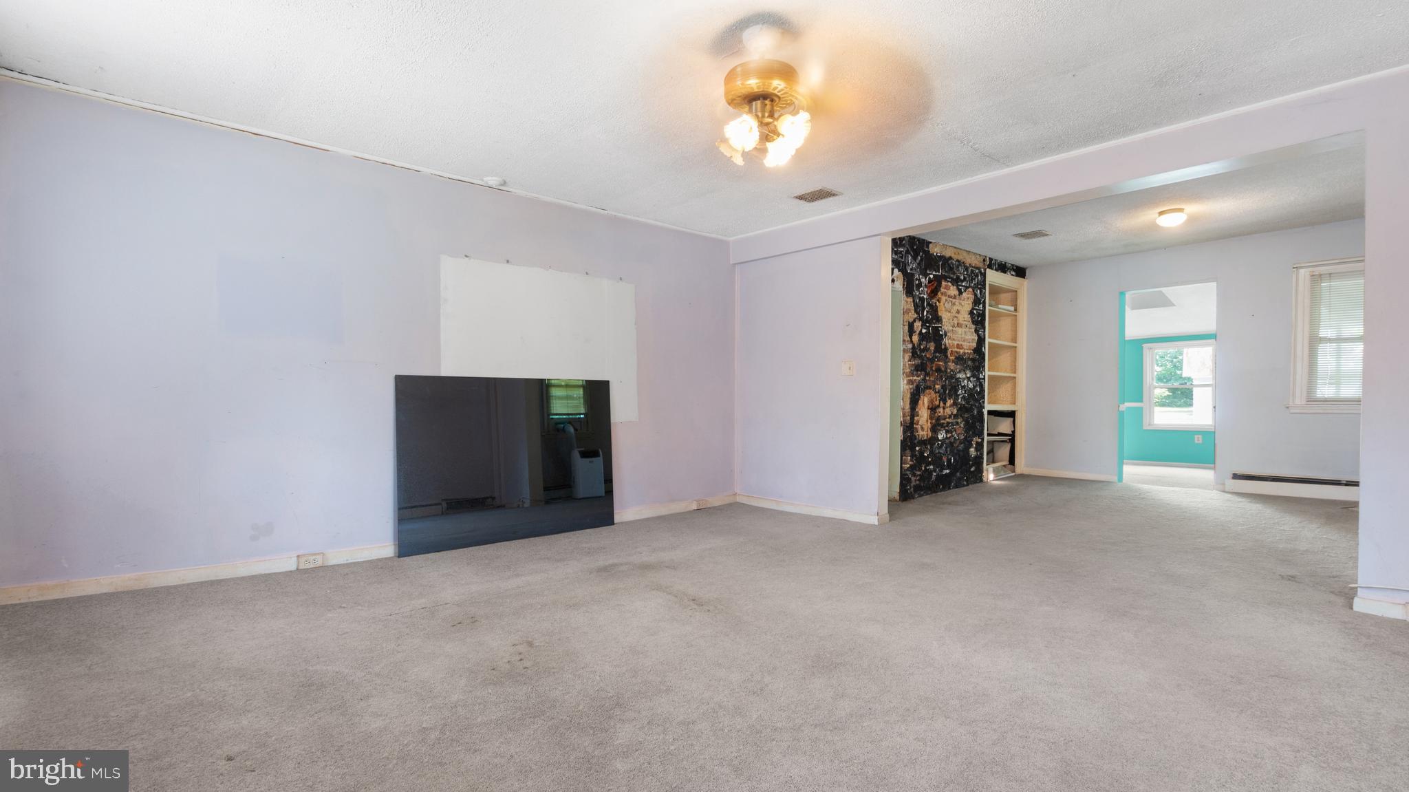 2207 Floral Park Road Clinton, MD 20735 - Photo 20 of 46 an empty room with a chandelier and a large window