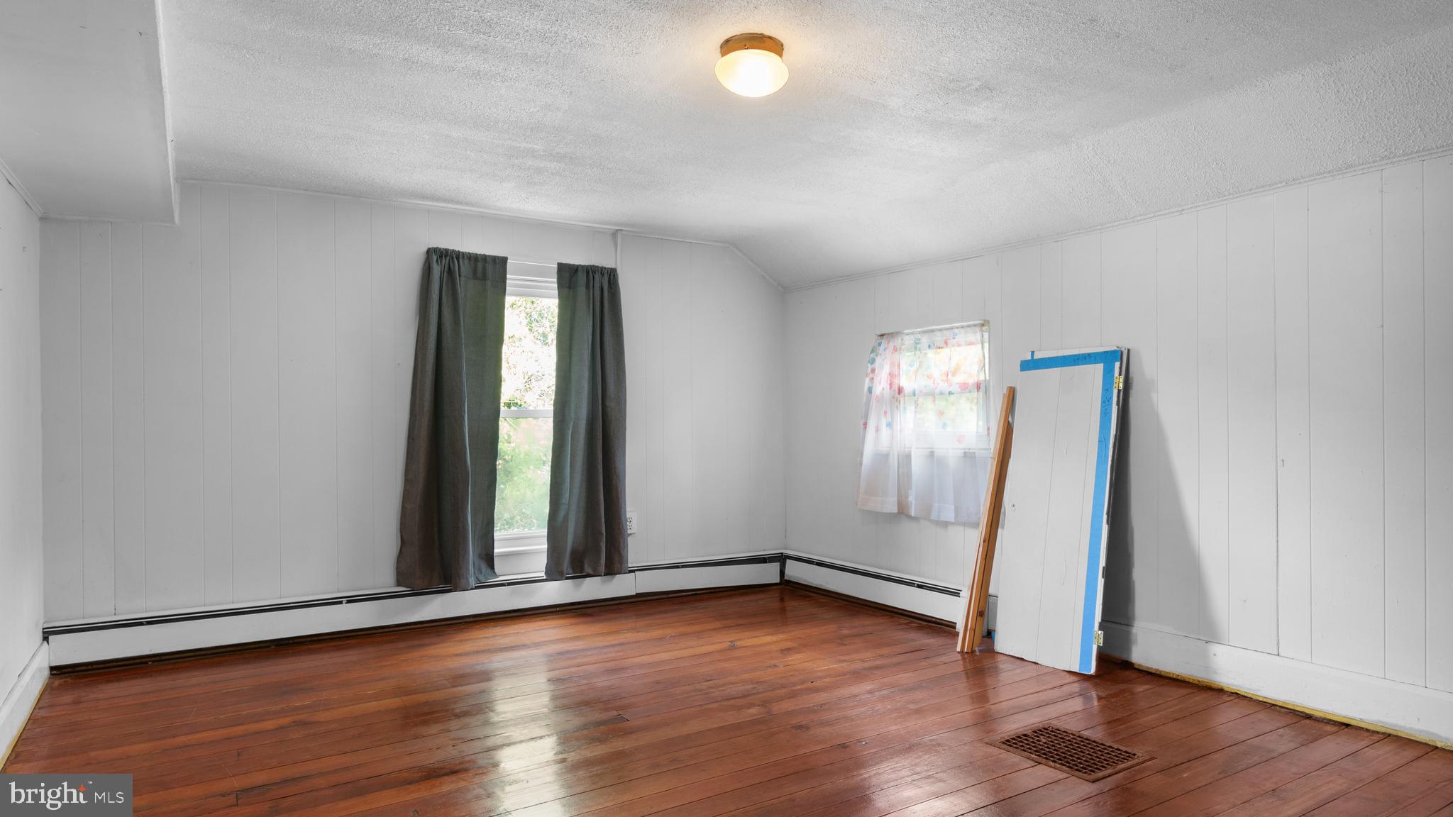 2207 Floral Park Road Clinton, MD 20735 - Photo 26 of 46 an empty room with wooden floor and windows