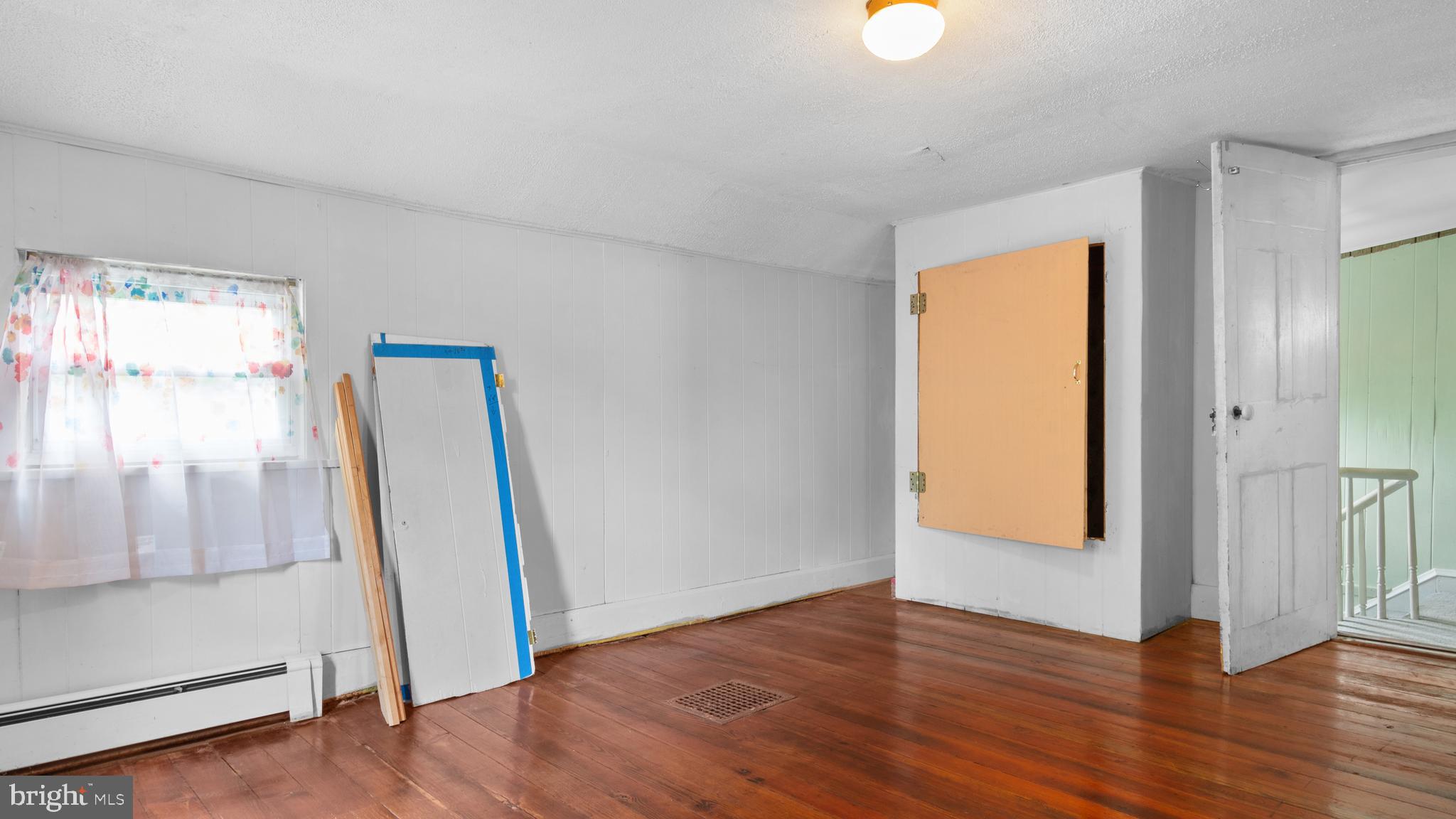 2207 Floral Park Road Clinton, MD 20735 - Photo 27 of 46 a view of an empty room with wooden floor and window