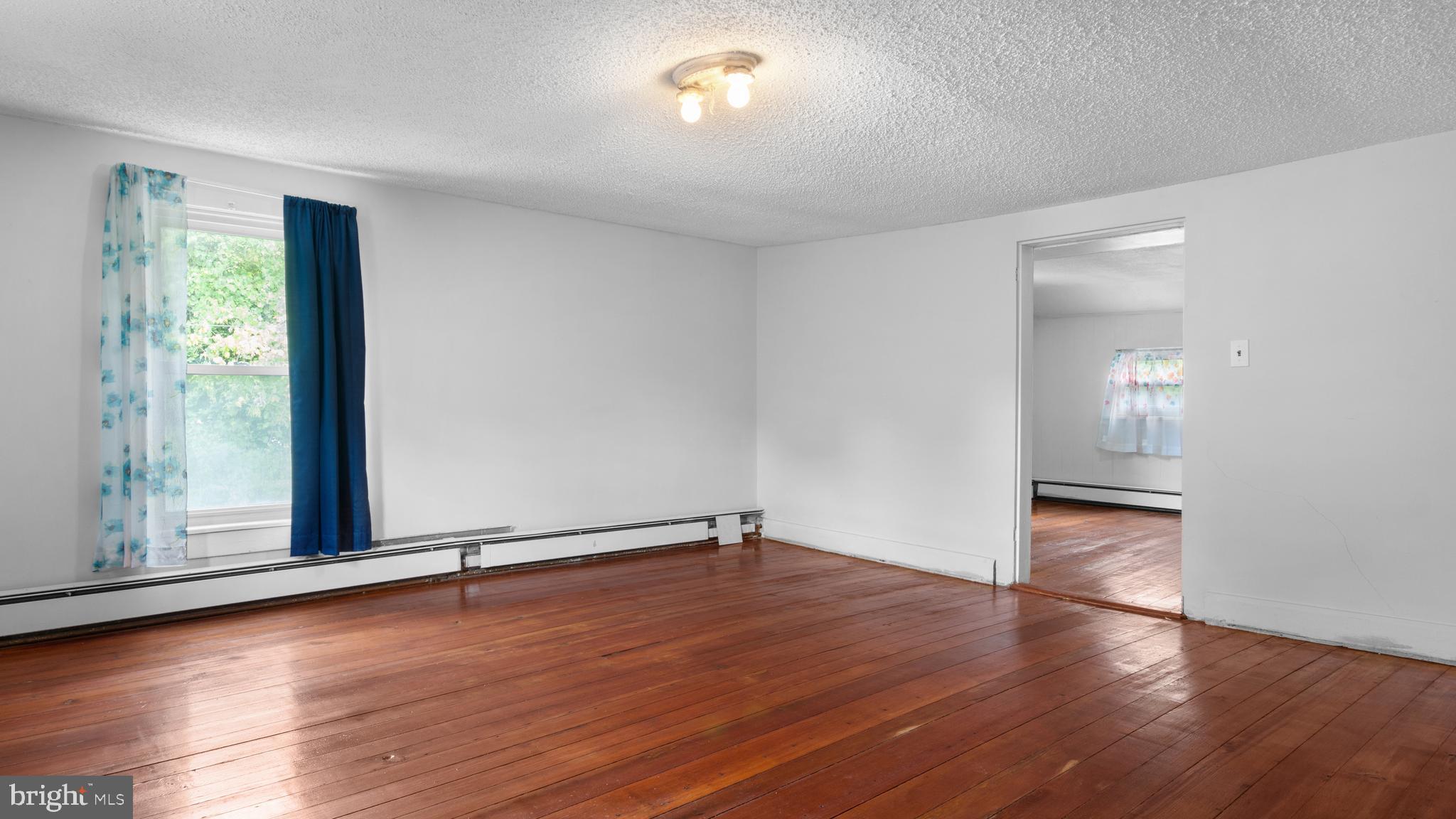 2207 Floral Park Road Clinton, MD 20735 - Photo 29 of 46 an empty room with wooden floor and windows