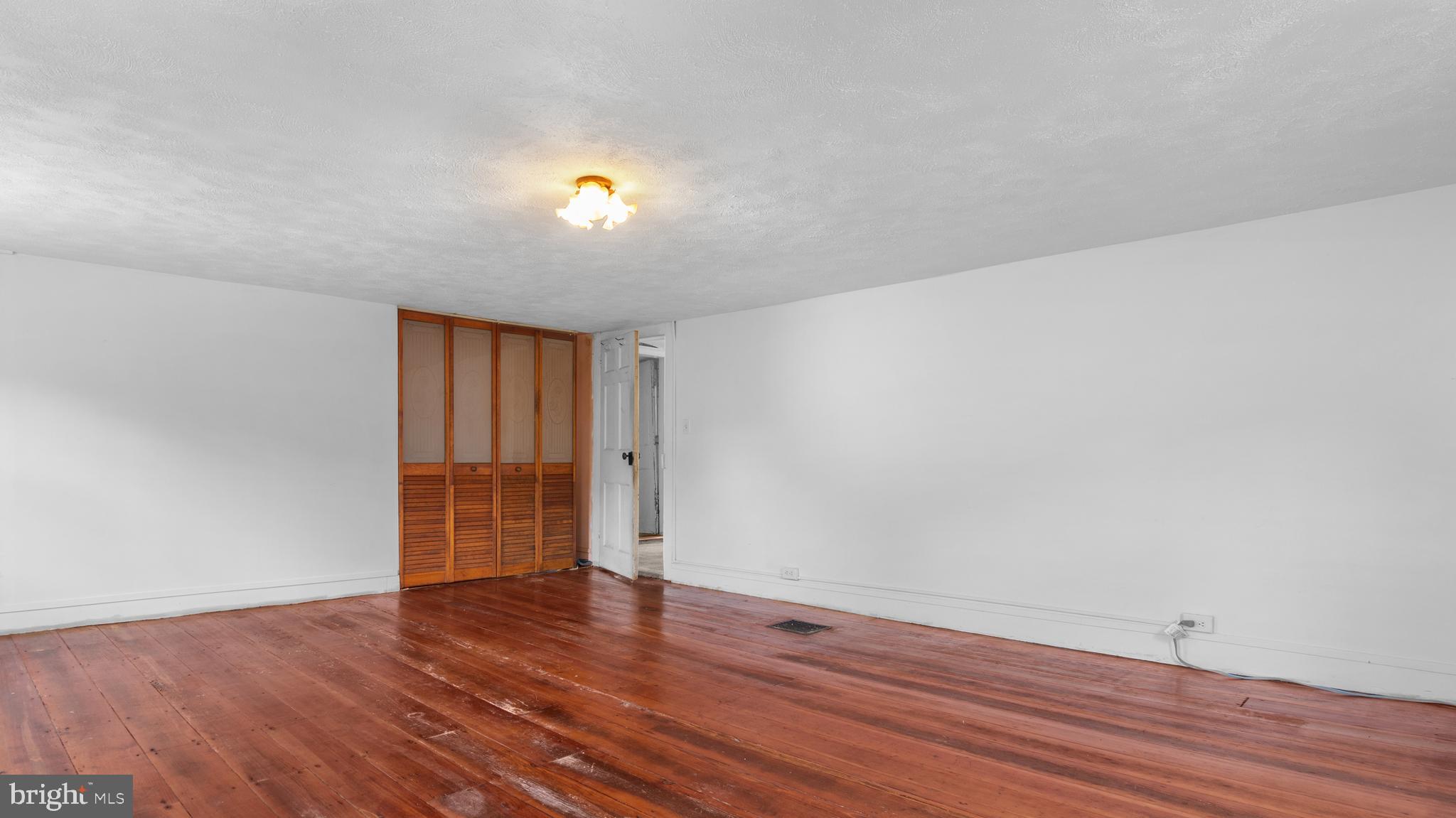 2207 Floral Park Road Clinton, MD 20735 - Photo 36 of 46 a view of an empty room with wooden floor and a window
