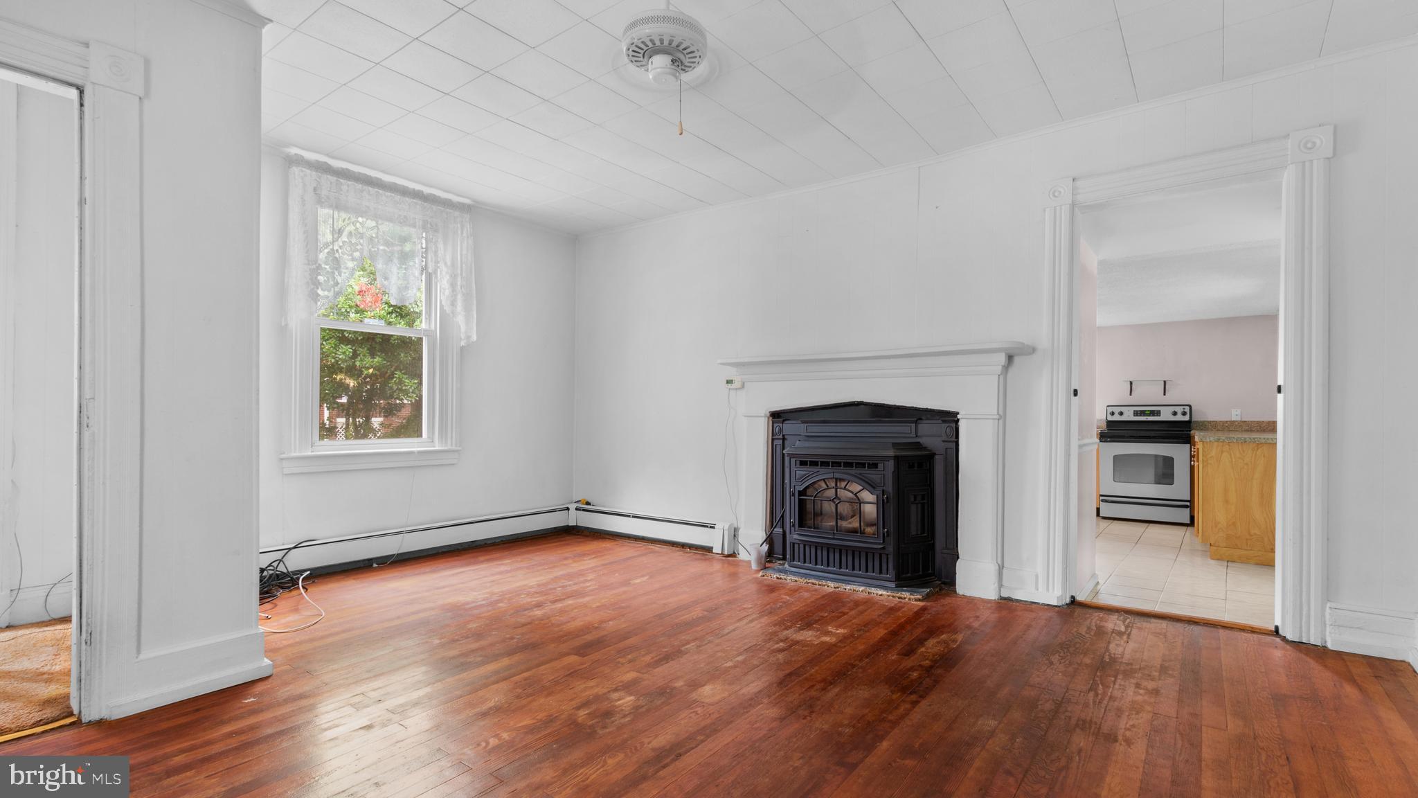 2207 Floral Park Road Clinton, MD 20735 - Photo 7 of 46 a view of empty room with wooden floor and fireplace