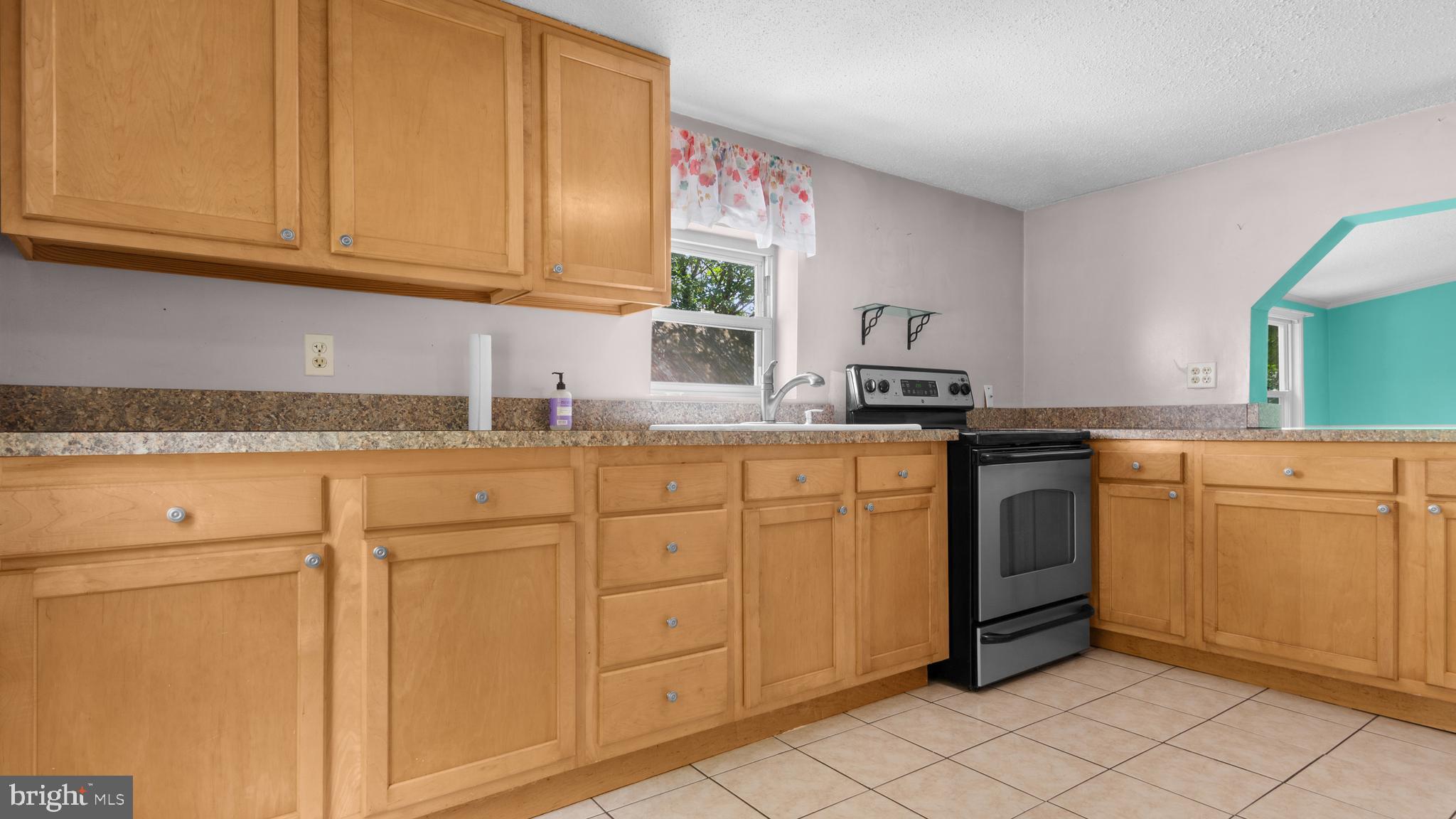2207 Floral Park Road Clinton, MD 20735 - Photo 8 of 46 a kitchen with granite countertop cabinets and white appliances