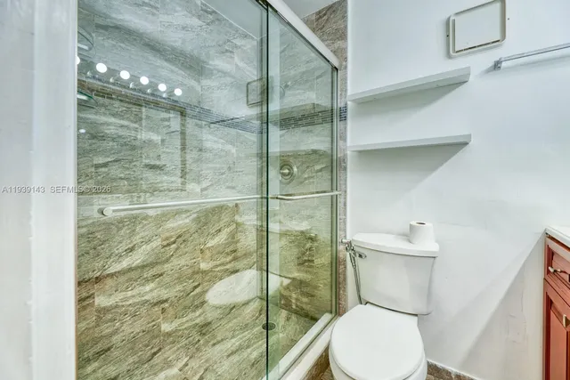 a bathroom with a toilet and a shower
