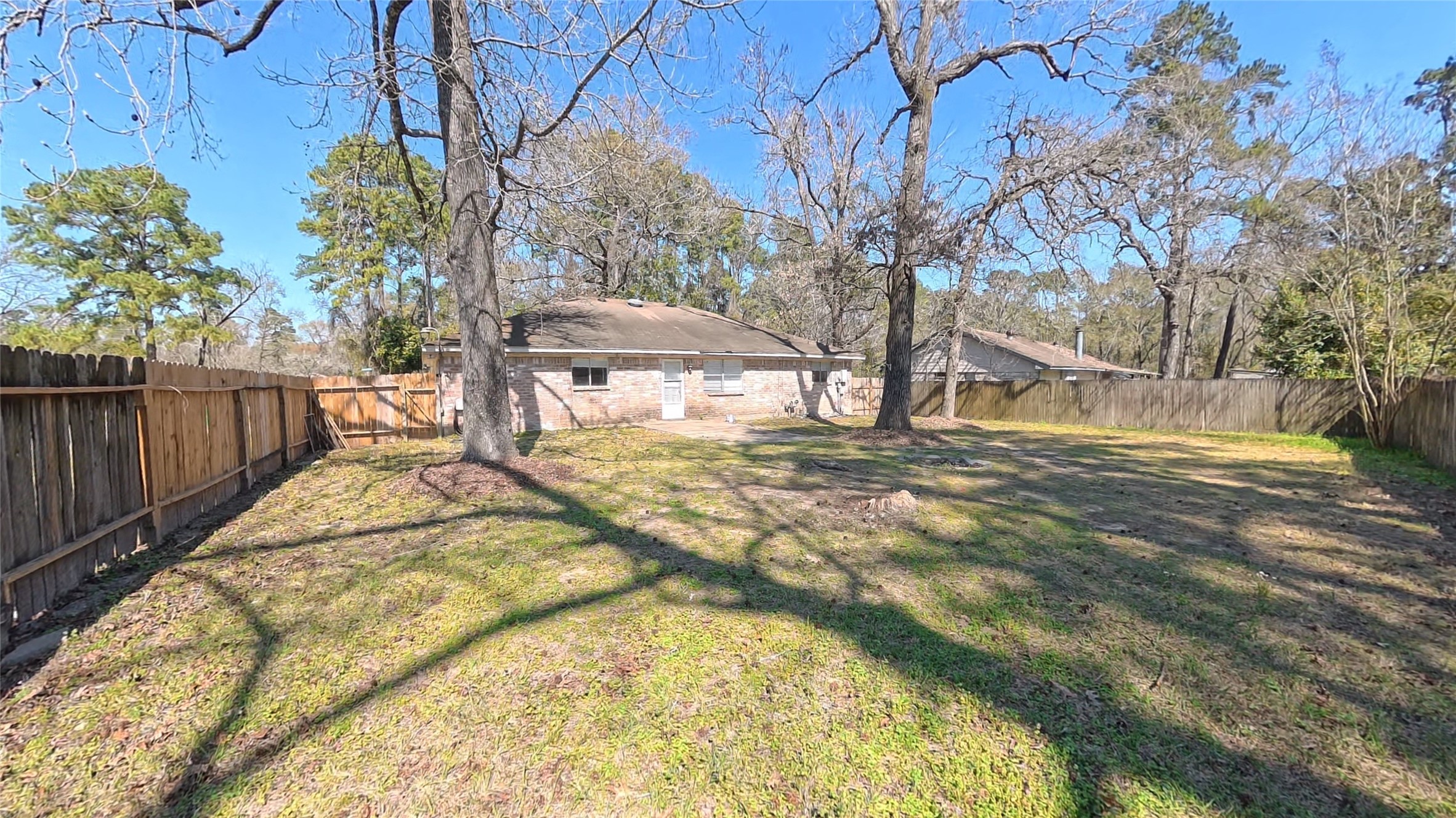 3327 Valerie Lane Spring, TX 77380 - Photo 10 of 11 a view of a yard with wooden fence
