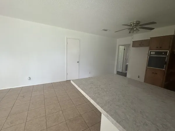 a view of a kitchen with a sink and a refrigerator
