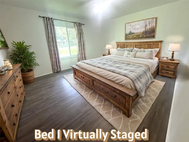 a bedroom with a bed and a large window