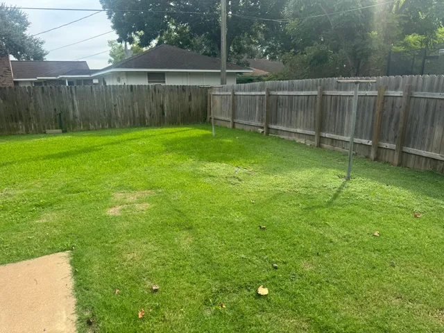 a view of a backyard with a fence