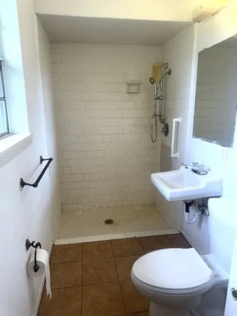 a bathroom with a sink toilet and a mirror