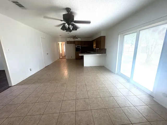 a view of a livingroom with a ceiling fan and window