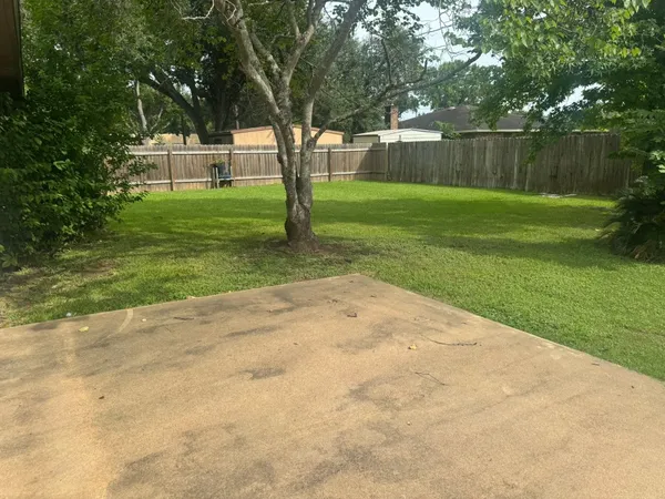 a backyard of a house with lots of green space