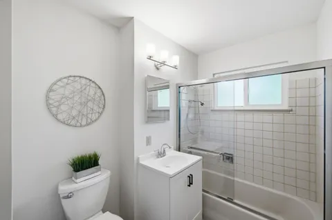 a bathroom with a toilet a sink and shower