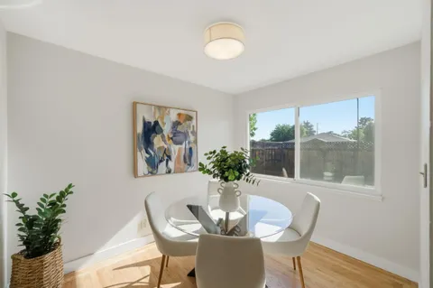 a dining room with furniture and wooden floor