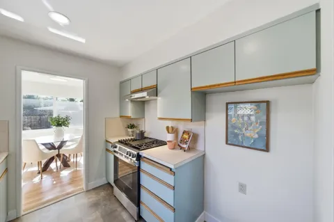 a kitchen with stainless steel appliances granite countertop a stove and a refrigerator