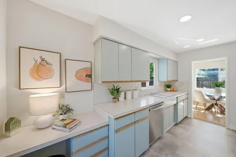 a kitchen with a sink cabinets and window