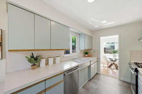 a kitchen with a sink a counter and cabinets
