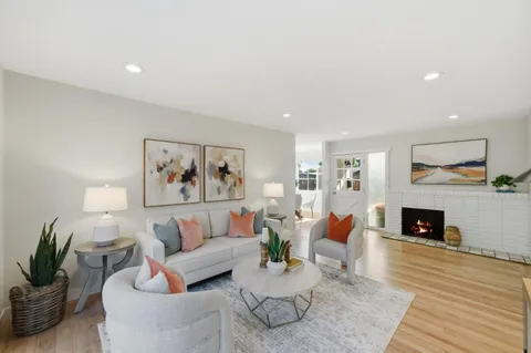 a living room with furniture fireplace and a fireplace