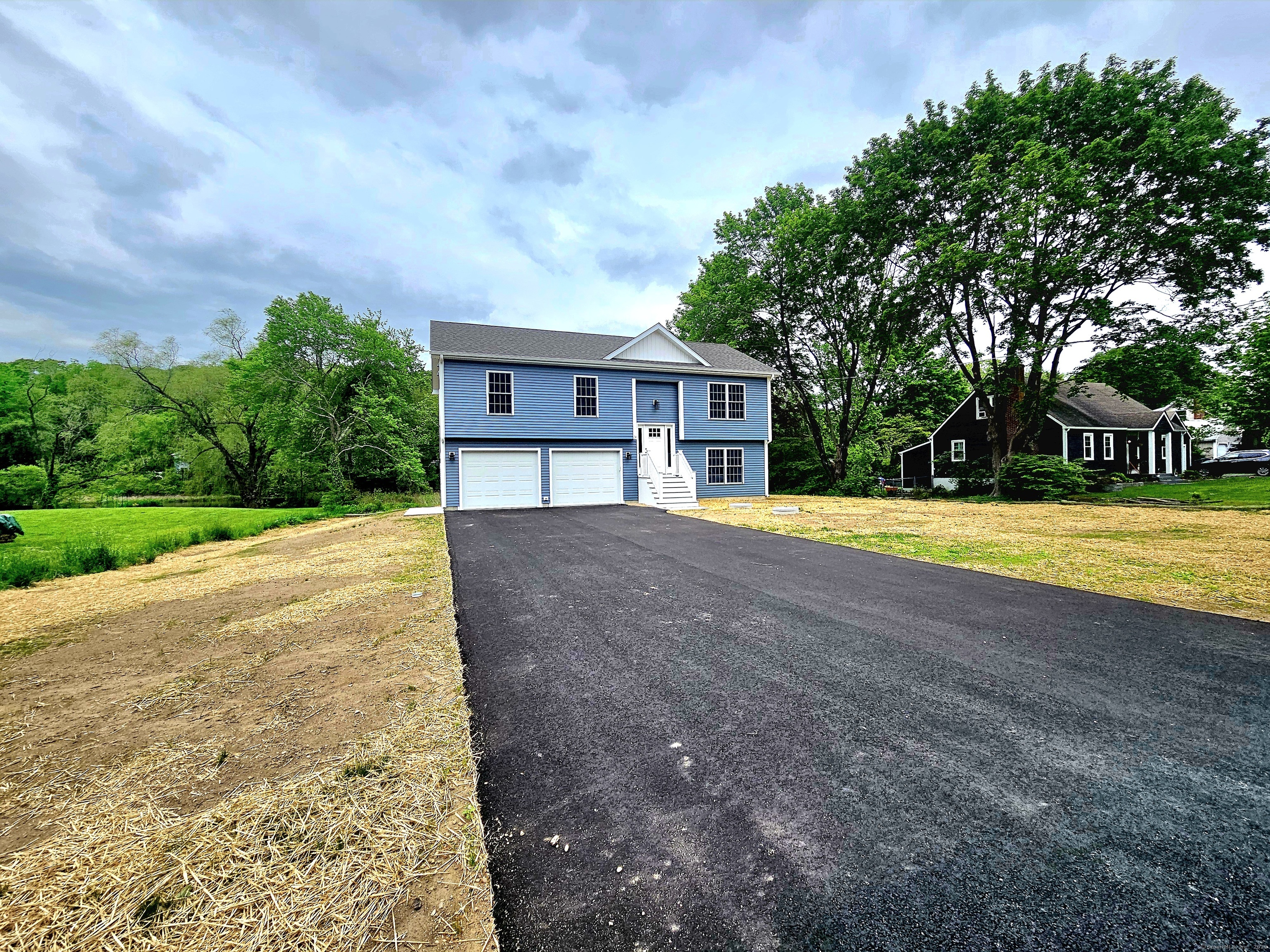 a view of house with swimming pool and yard