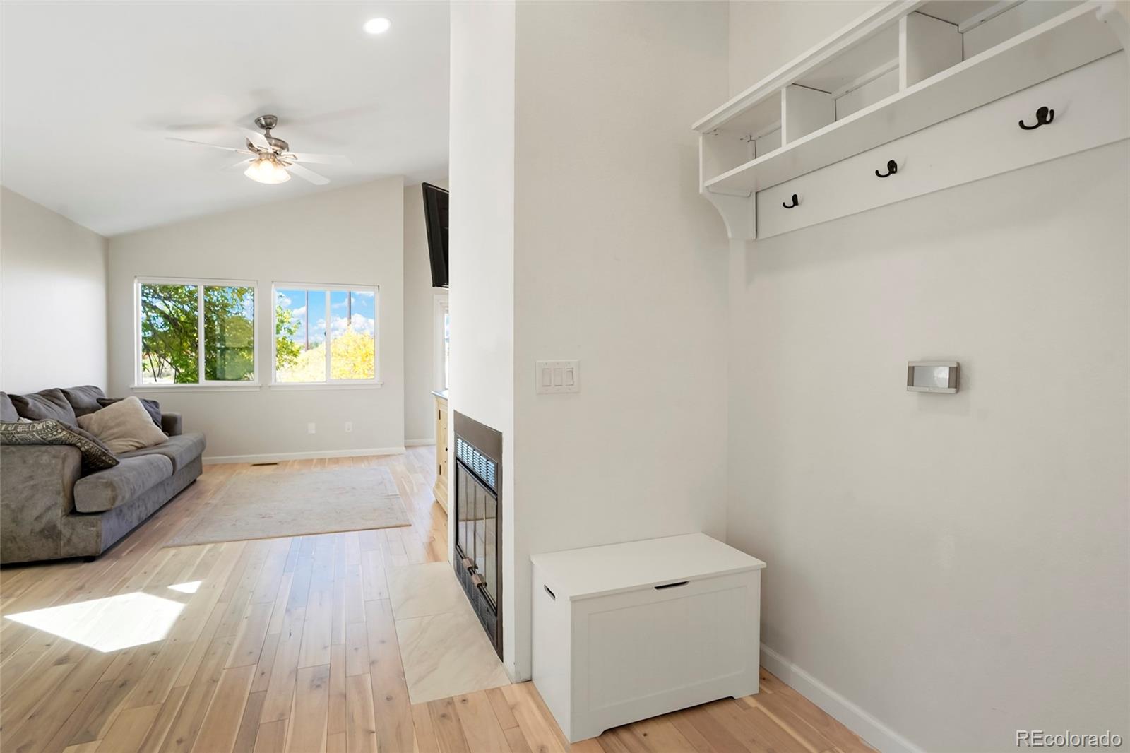 535 Howe Street Castle Rock, CO 80104 - Photo 11 of 25 a hallway with a couch and a window with wooden floor