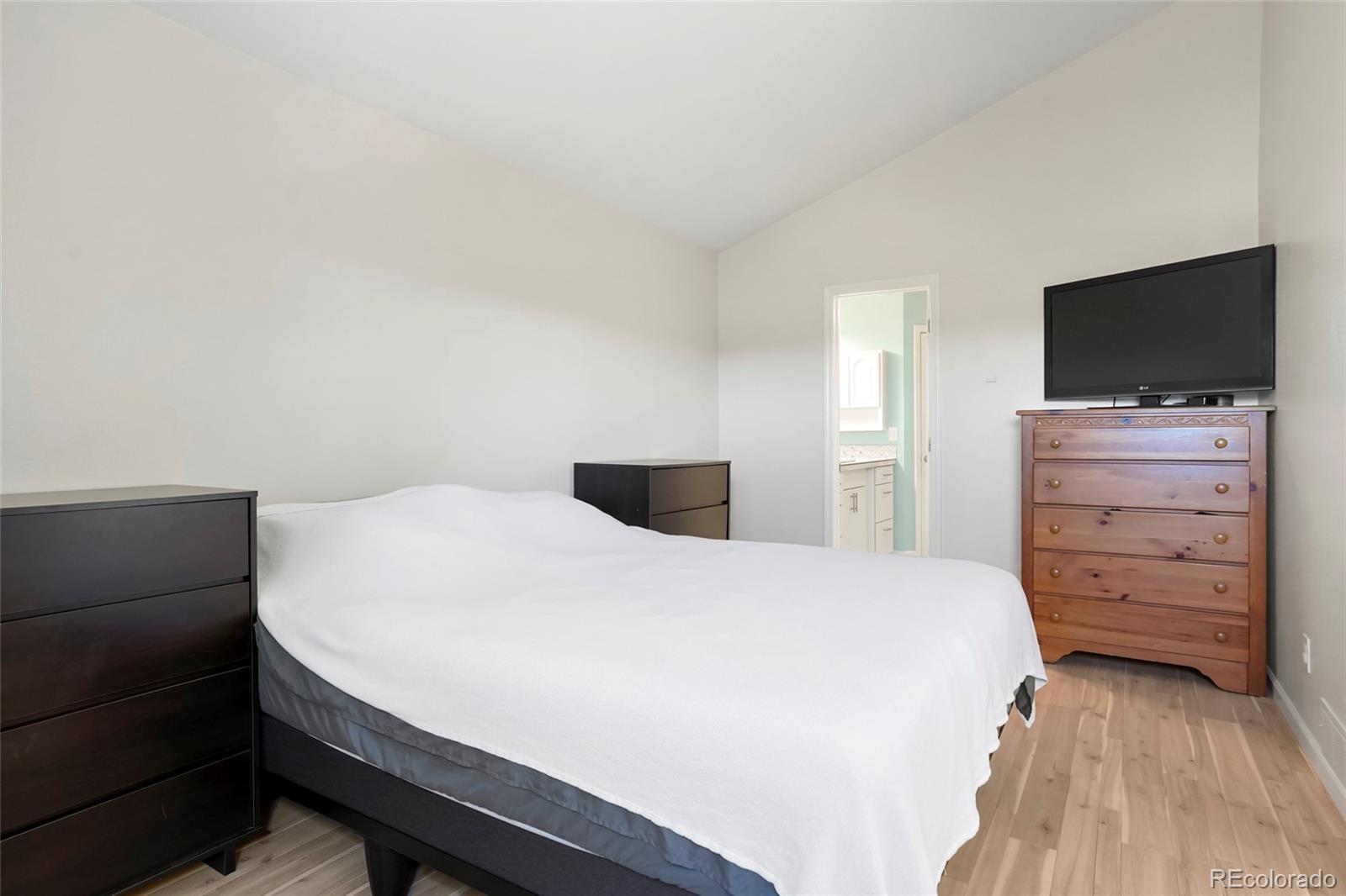 535 Howe Street Castle Rock, CO 80104 - Photo 12 of 25 a bedroom with a bed and flat screen tv