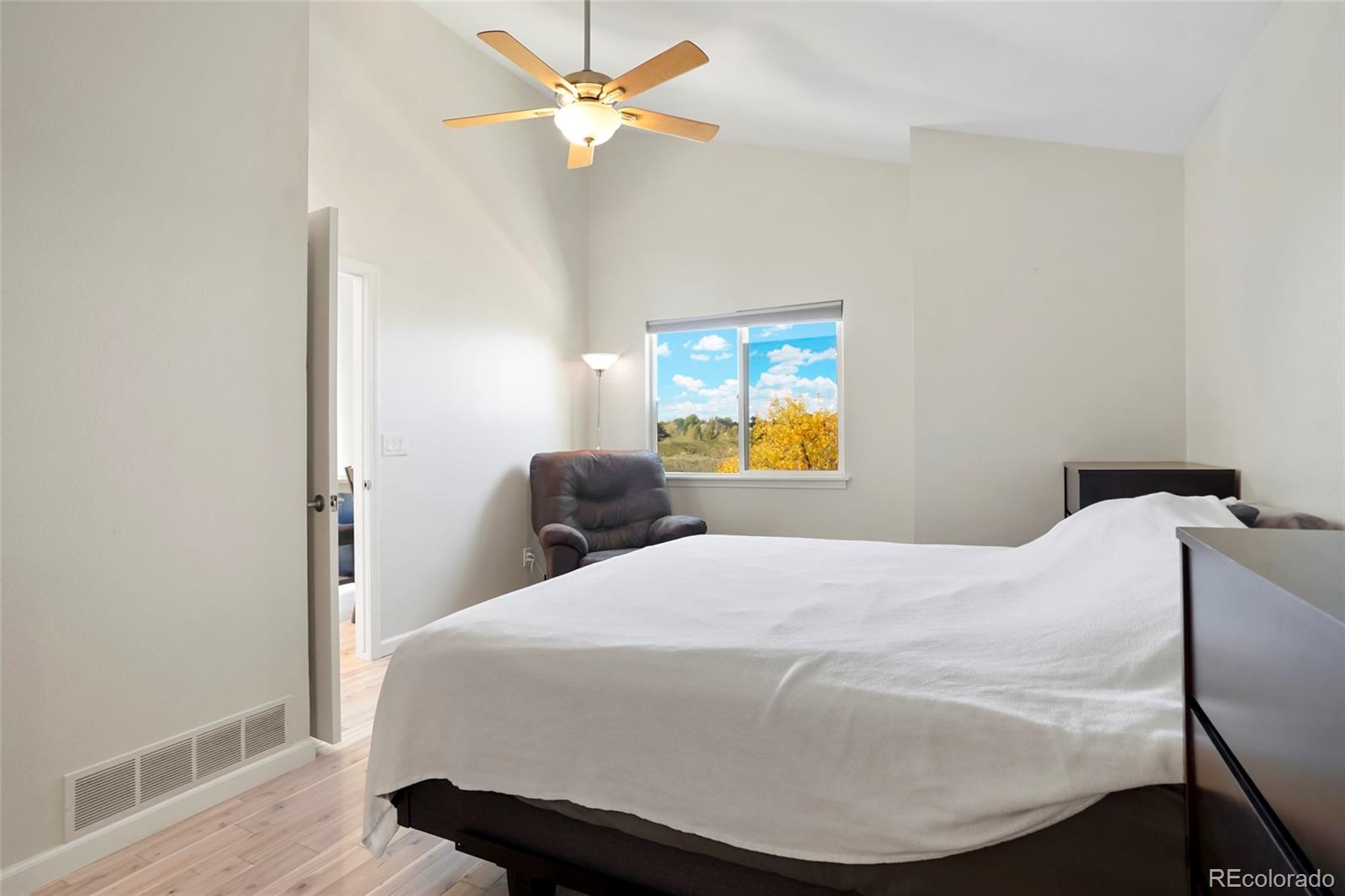 535 Howe Street Castle Rock, CO 80104 - Photo 13 of 25 a bedroom with a bed and wooden floor