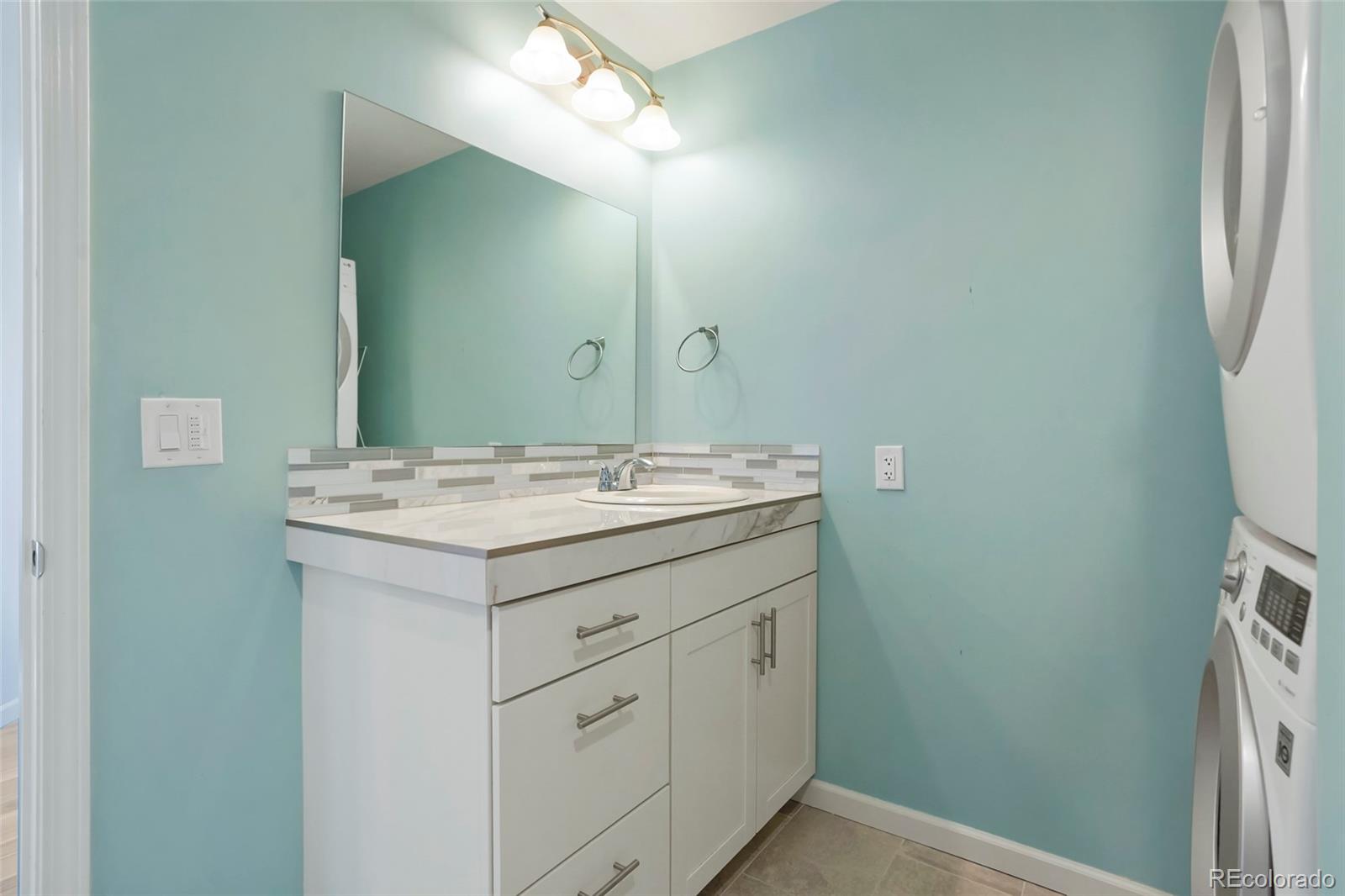 535 Howe Street Castle Rock, CO 80104 - Photo 18 of 25 a bathroom with a sink and a mirror