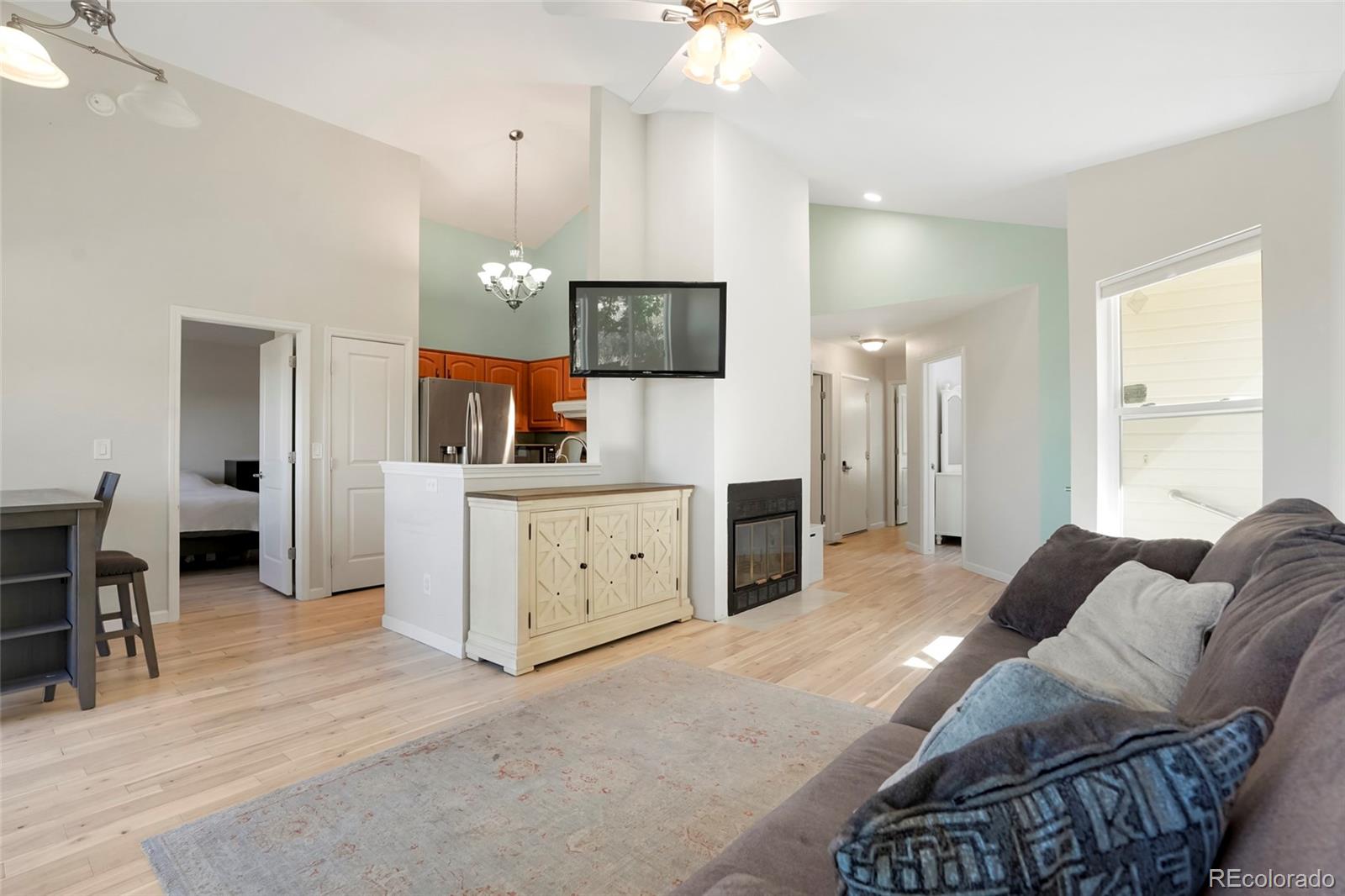 535 Howe Street Castle Rock, CO 80104 - Photo 4 of 25 a living room with furniture a dining table and a refrigerator