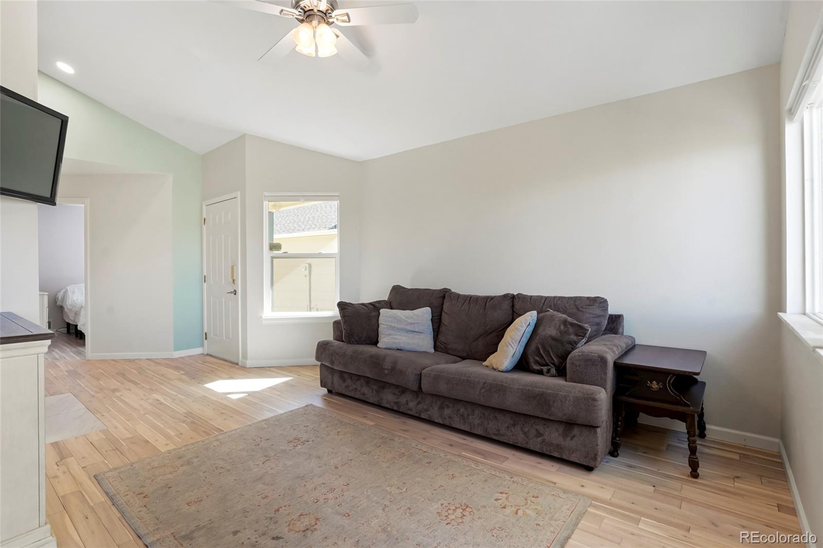 535 Howe Street Castle Rock, CO 80104 - Photo 5 of 25 a living room with furniture and a flat screen tv