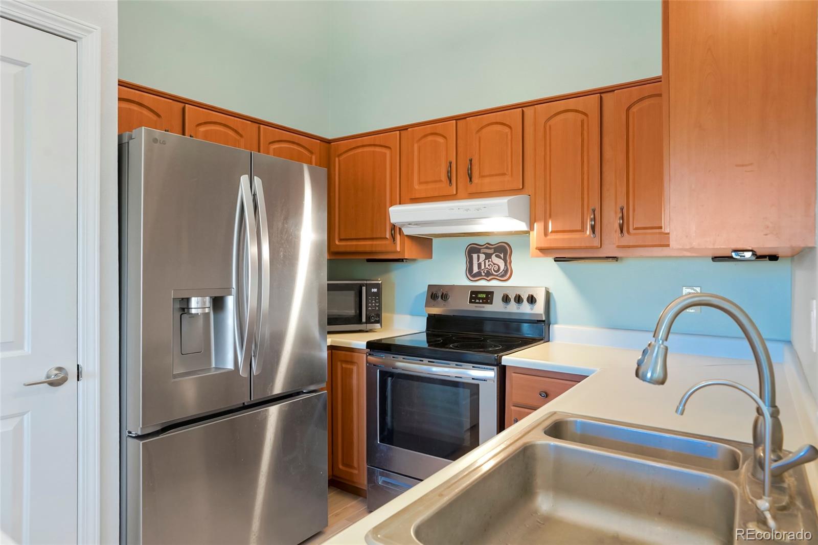 535 Howe Street Castle Rock, CO 80104 - Photo 9 of 25 a kitchen with stainless steel appliances granite countertop a refrigerator and a stove top oven