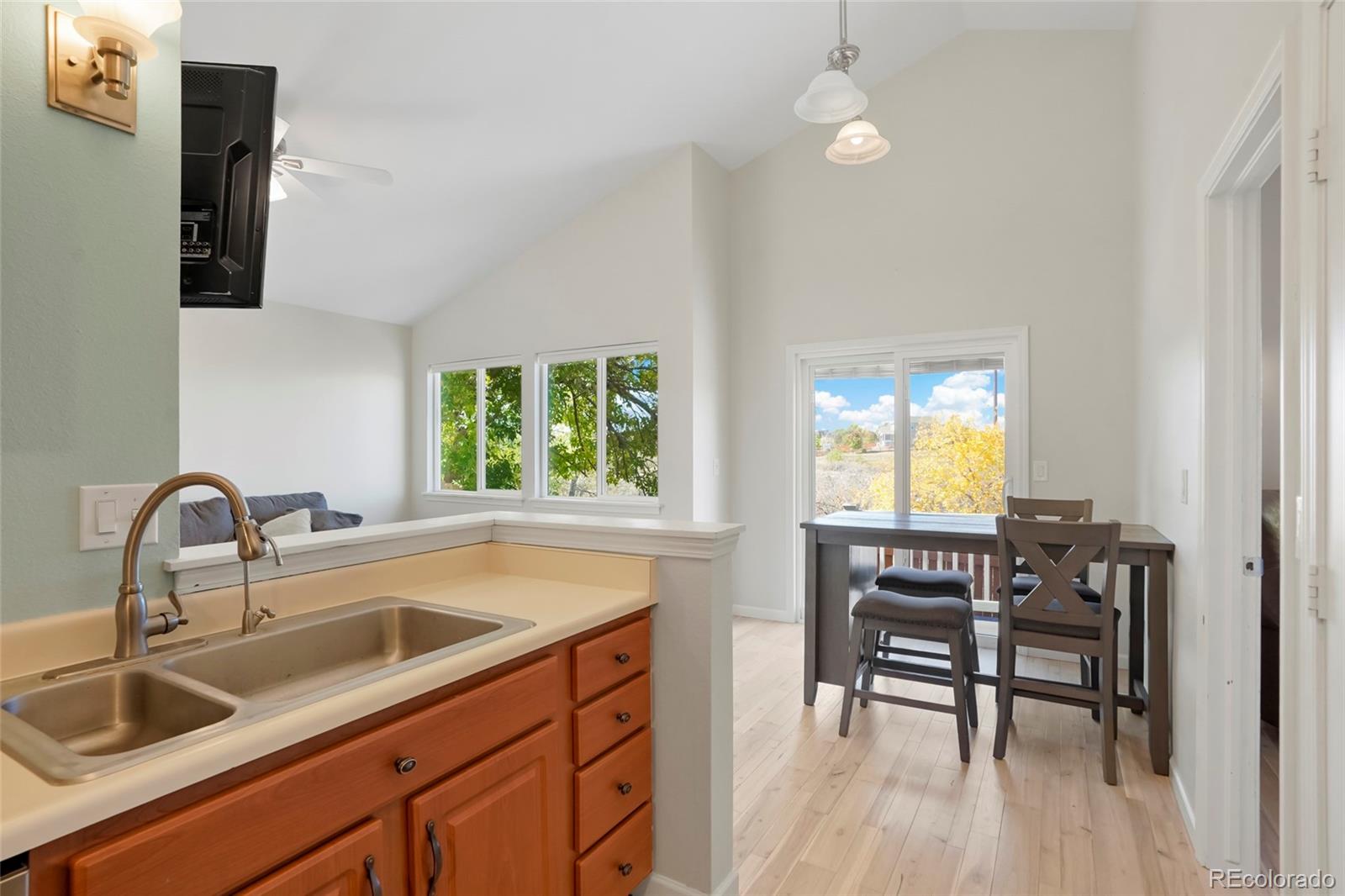 535 Howe Street Castle Rock, CO 80104 - Photo 10 of 25 a kitchen with a table chairs sink and cabinets