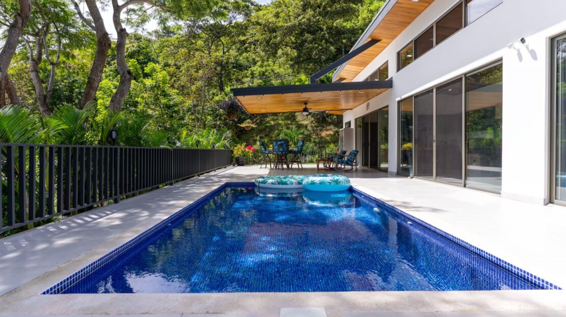 View of swimming pool featuring a patio, a fenced backyard, and outdoor dining space