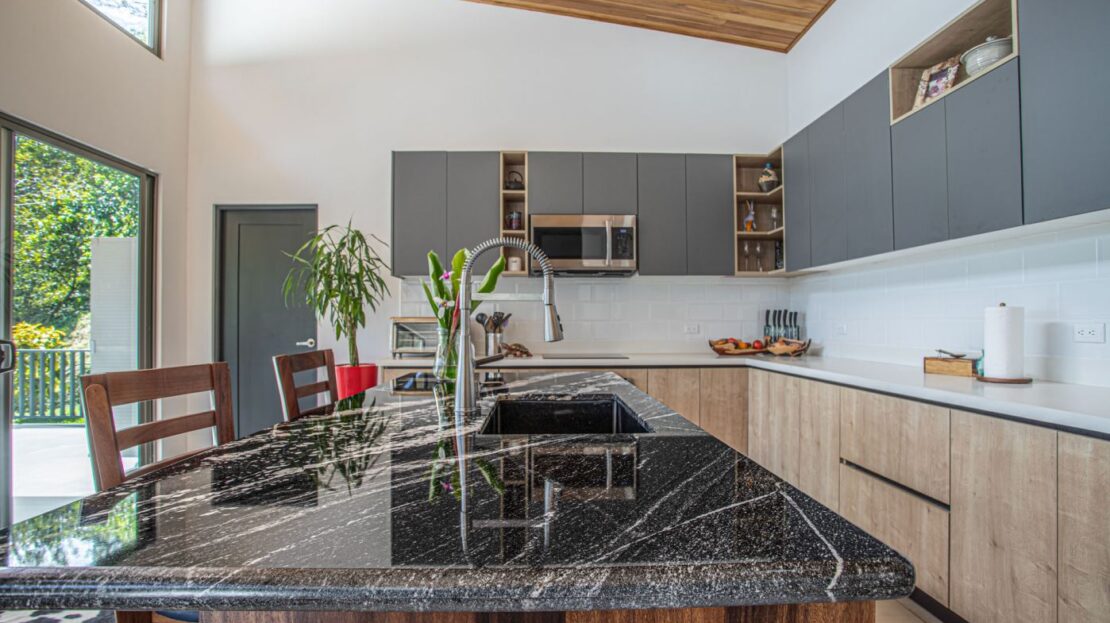 0 Modern Gem In The Natural Setting Washington, OS 20006 - Photo 5 of 33 Kitchen with open shelves, stainless steel microwave, gray cabinetry, modern cabinets, and a kitchen island with sink