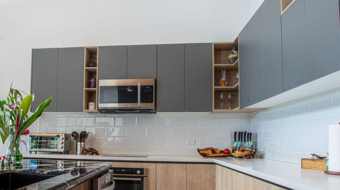 0 Modern Gem In The Natural Setting Washington, OS 20006 - Photo 6 of 33 Kitchen with open shelves, modern cabinets, stainless steel microwave, oven, and tasteful backsplash